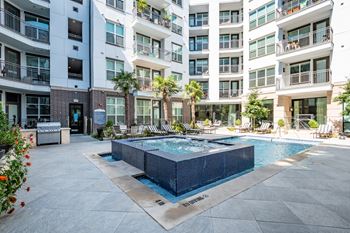 A pool surrounded by apartment buildings.